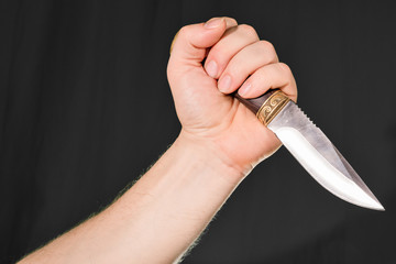Man's hand holding knife