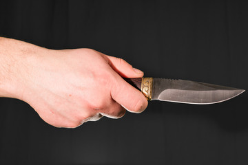 Man's hand holding knife