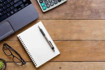 Office stuff with laptop, calculate , pen,and leather notebook.Top view with copy space
