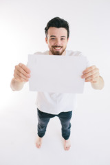 Bearded man holding a blank white sheet of paper