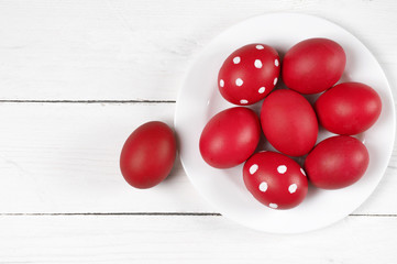 Naklejka na ściany i meble Red Easter eggs in plate