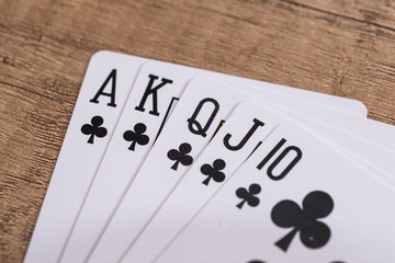 Set of Clubs suit playing cards on wooden desk