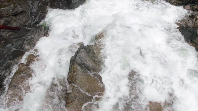 Top View of White Water Flowing Over Waterfall Edge Close Up