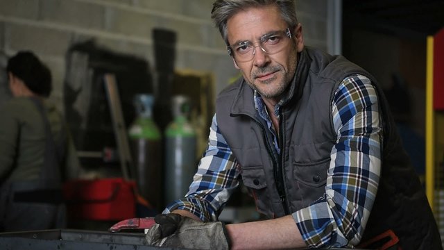 Portrait of middle-aged metalworker in workshop