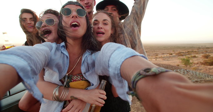 Road Trip hipster friends taking selfie during sunset with phone