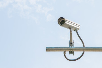 Security camera on blue sky background