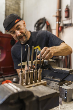Knife maker in workshop at work