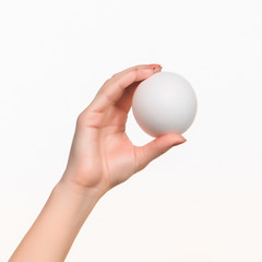 Fototapeta na wymiar The female hand holding white blank styrofoam ball 