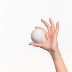 Fototapeta na wymiar The female hand holding white blank styrofoam ball 