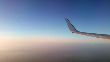 View of an aircraft wing during flight at sunset