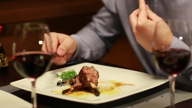 man eating meat in restaurant