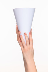 The cone in female hands on white background