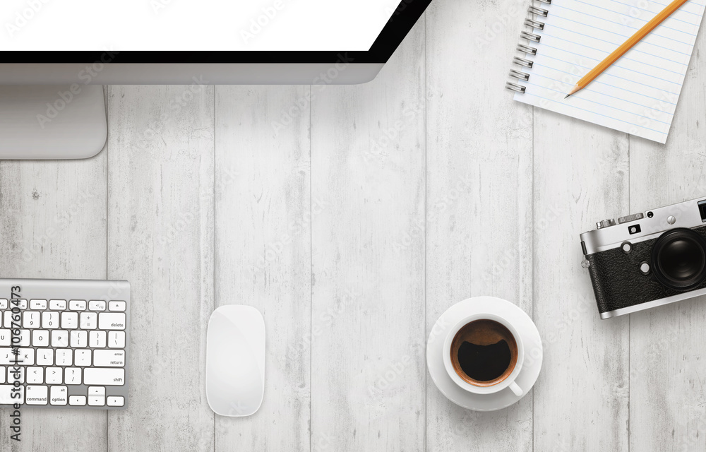 Poster work desk with free space for text. computer display, coffee, camera, notepad, pencil on wooden tabl