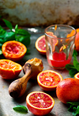the fresh bloody oranges cut in half on a vintage metal tray.
