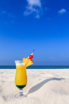 Fruity cocktail is on a beach