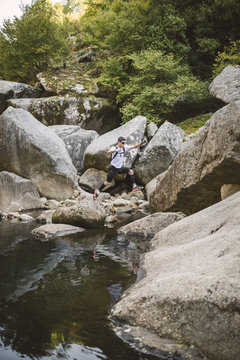 Spain, A Capela, ultra trail runner crossing a river