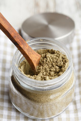 A glass jar of protein-rich hemp seed powder