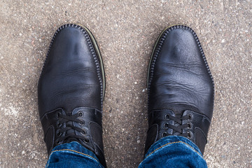 Black shoes on his feet