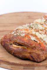 Pizza sandwich on wooden board over white