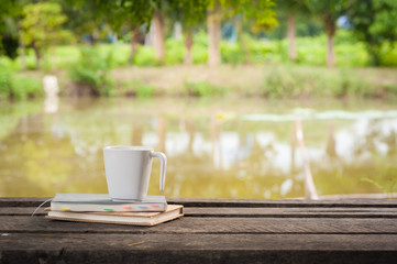 Coffee cup with notebook on rustic wood table