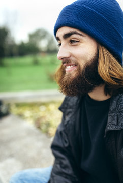 Portrait of smiling young man wearing blue woolly hat