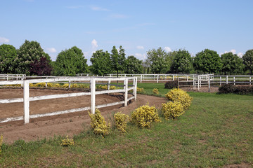 ranch with white corral for horses