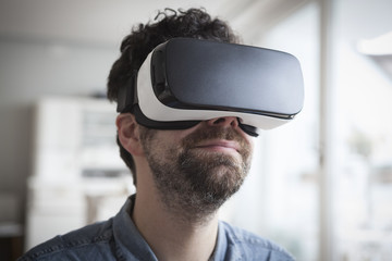 Smiling man wearing Virtual Reality Glasses