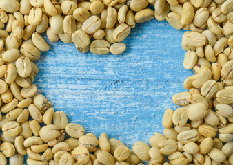 Coffee Beans Heart background , Blue wooden desk top view.