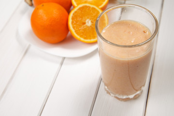 Healthy drink orange and banana smoothies on wooden table