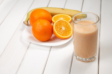 Healthy drink orange and banana smoothies on wooden table