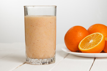 Healthy drink orange and banana smoothies on wooden table