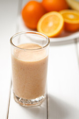 Healthy drink orange and banana smoothies on wooden table