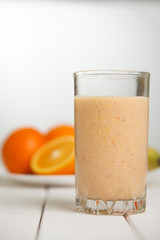 Healthy drink orange smoothies on wooden table
