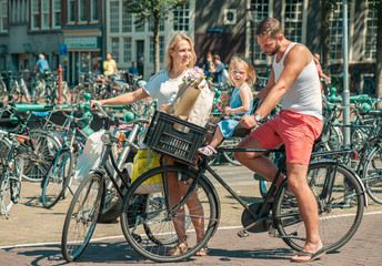 Parents cycling at the streets of Amsterdam