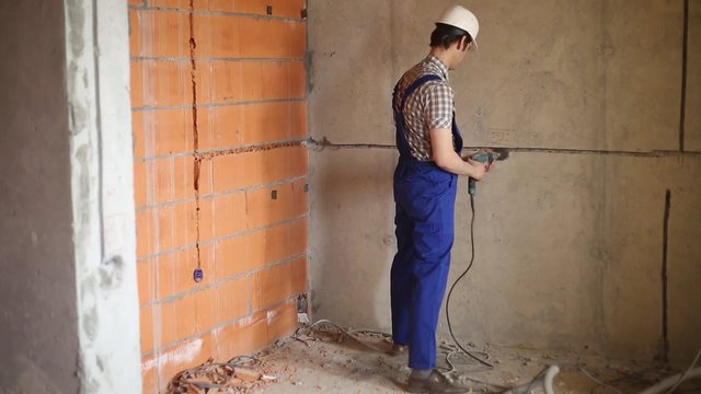 Man works with perforator