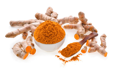 Turmeric roots with turmeric powder on white background
