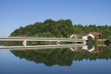 red car, bridge, house and forest