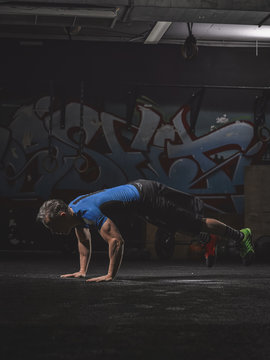 Mature  athlete exercising doing burpees