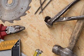 Tools set on osb panel with copy space.  Carpenter workplace on wooden background. Top view.