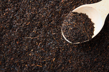 loose tea with a wooden spoon closeup