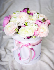 big bouquet of summer flowers in round box over white