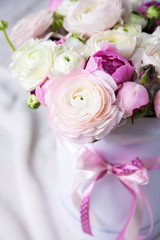 close up of beautiful bunch of summer flowers in box over white