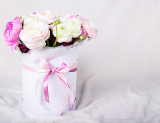 beautiful bunch of summer flowers in round box over white
