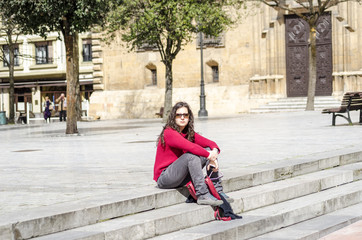 Young woman sitting and relaxing in a sunny day a square of Ovie