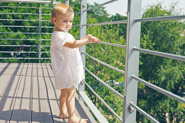 Baby staying on the balcony - 106777425