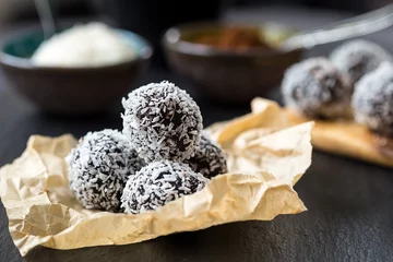Fototapeten Homemade Healthy Paleo Raw Chocolate Truffles with Nuts, Dates and Coconut Flakes © toyechkina