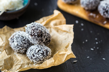 Homemade Healthy Paleo Raw Chocolate Truffles with Nuts, Dates and Coconut Flakes, Close-up