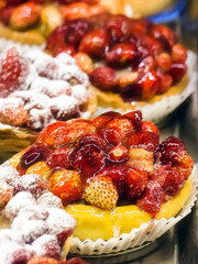 Tart wild strawberries on cream yellow.