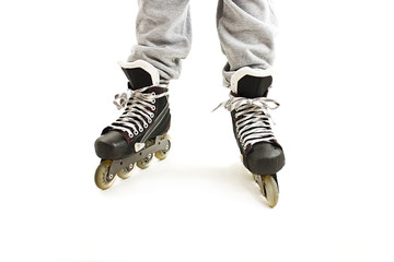 Close up a Boy Legs in Roller Skates. Isolated On White Background 
