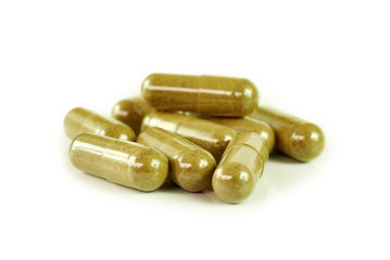 Herbal drugs capsules isolated on white.